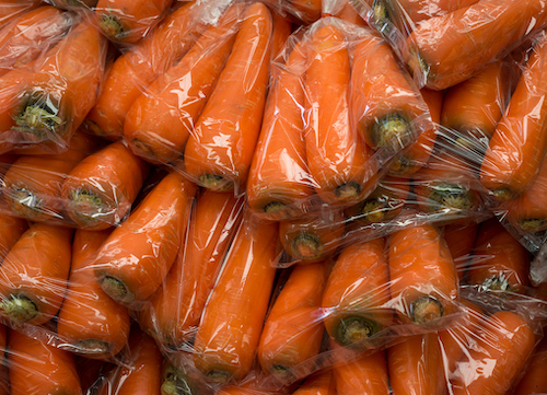 Group of fresh orange carrot in plastic bag sold at a market