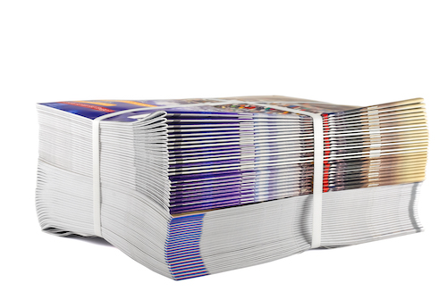 Pile of bundled magazines isolated on white background